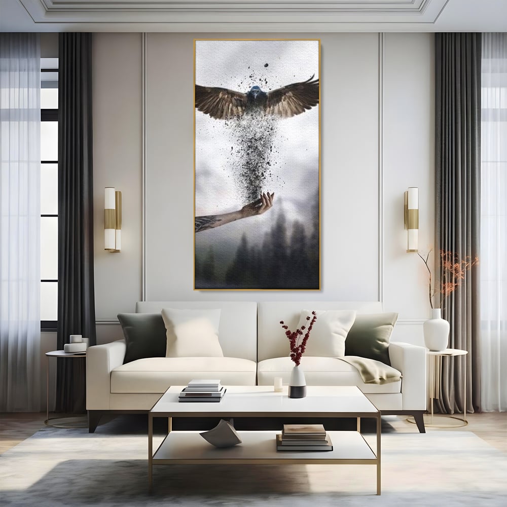 Tablou canvas cu tablou canvas cu pasare si mana din cenusa, in rama de aluminiu auriu, pe perete intr-un living
